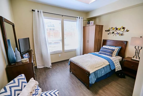 Cozy resident room with a bed and personal decor