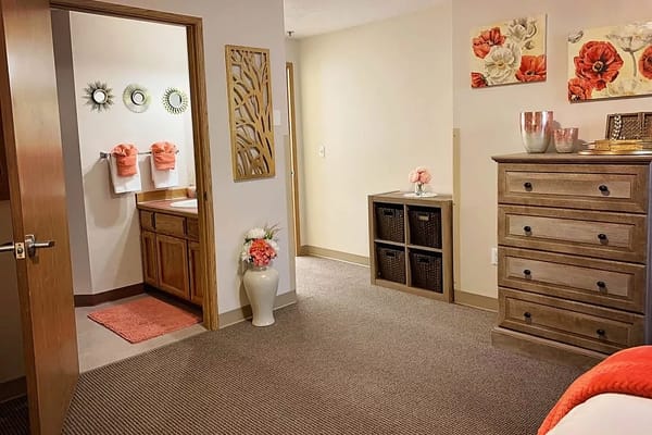 Interior of a cozy bedroom and bathroom area with decorative elements