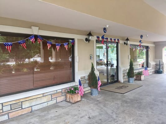 Exterior entrance of a senior care facility with decorations
