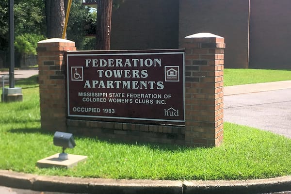 Sign for Federation Towers Apartments in Hattiesburg, MS.