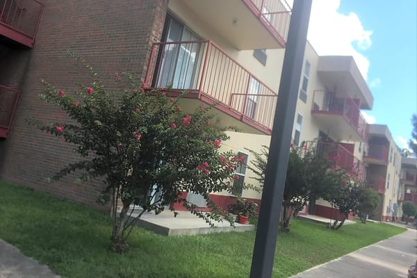 Exterior view of Federation Towers with blooming flowers.