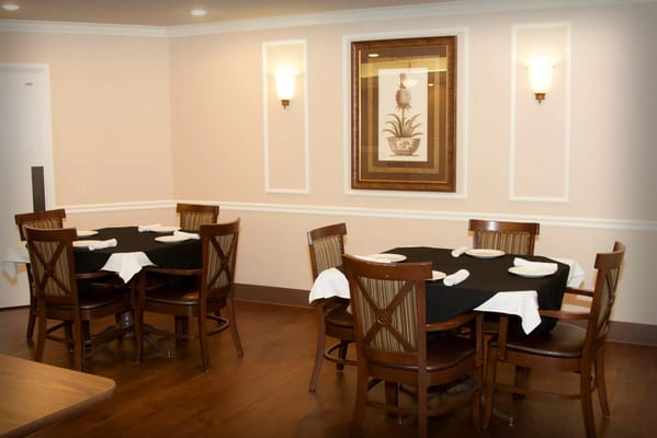 Dining area with tables and chairs set for meals