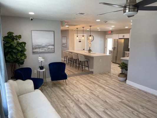 Bright common area with seating and kitchen view