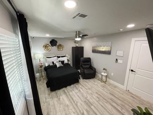 A cozy private resident room with a bed and chair