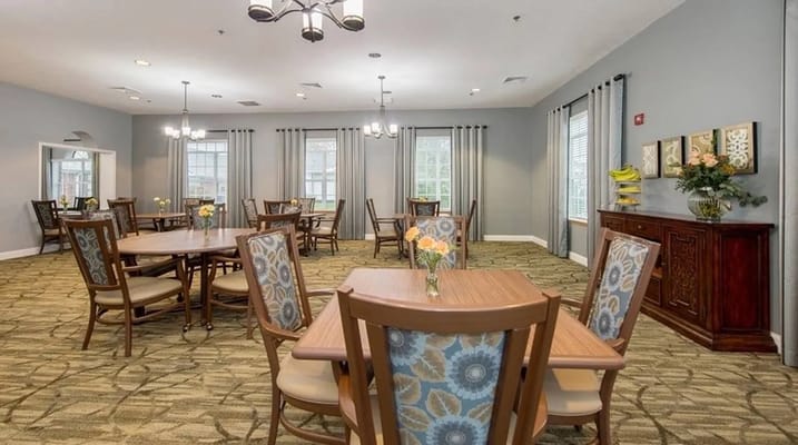 Bright dining room with tables and floral arrangements