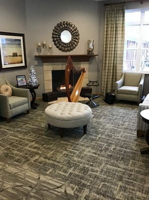 Cozy interior lounge area with a harp and comfortable seating