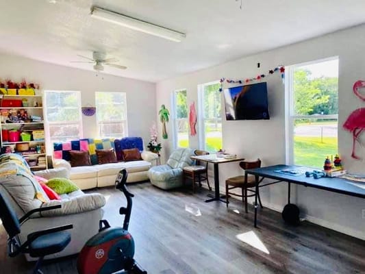 Bright common area with seating and activities