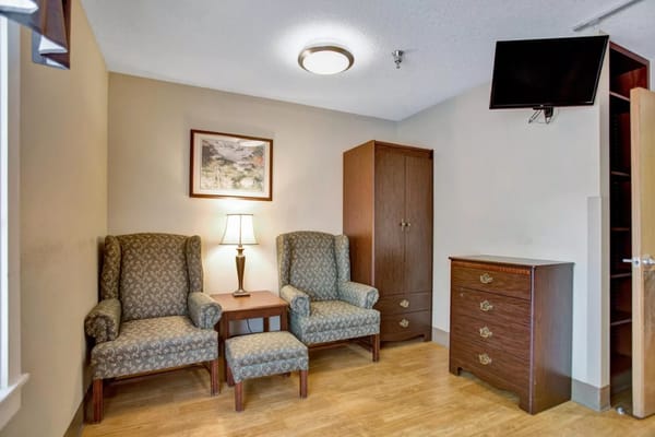 Cozy resident room with two chairs and storage