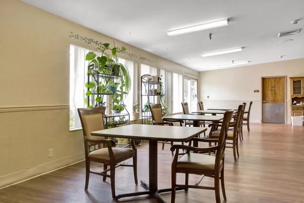 Bright and spacious common area with tables and plants
