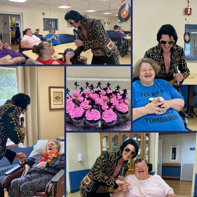 A performer dressed as Elvis sings to residents at a senior living facility, with cupcakes in view.