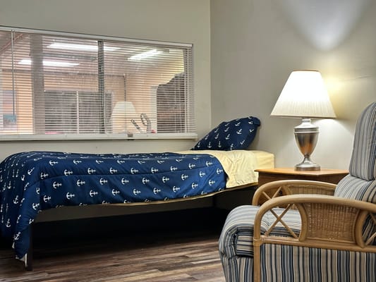 Cozy resident room with a bed and lamp