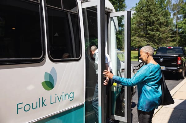 Residents boarding a Foulk Living shuttle bus