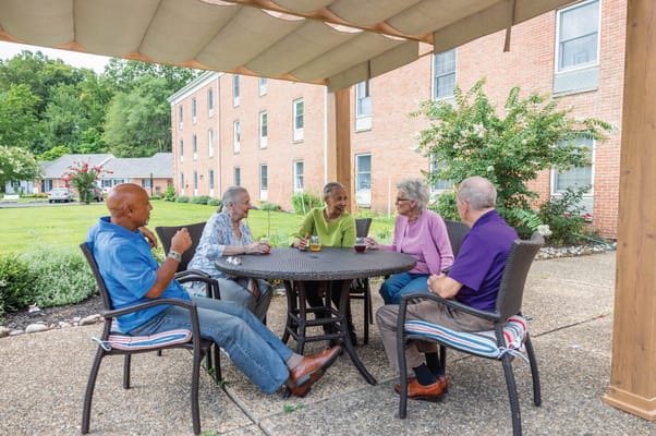 Residents socializing at a table outdoors