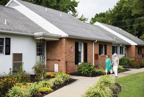 Two residents walking on a landscaped pathway
