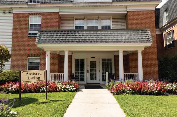 Front entrance of an assisted living facility with flowers