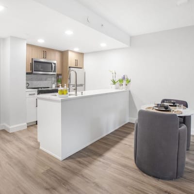 Modern kitchen and dining area in a senior living unit