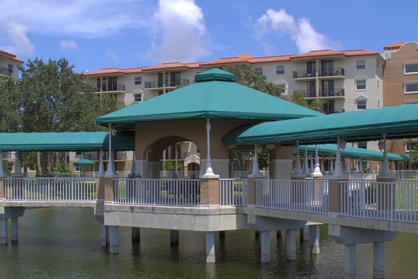 Gazebo with green awnings by the lake at Fountainview senior living facility.