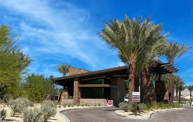 Exterior view of the facility entrance with palm trees