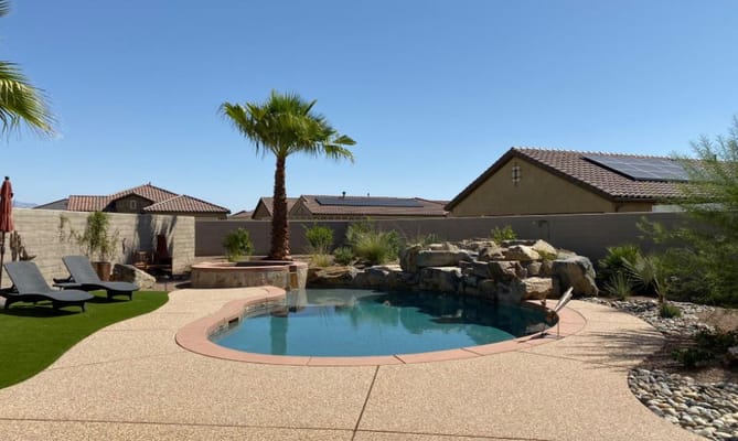 A sunny outdoor pool area with palm trees and lounge chairs
