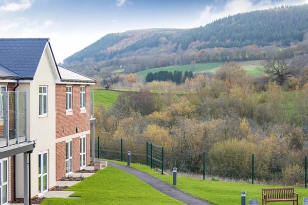 Exterior view of a facility with mountains in the background