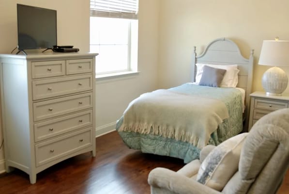 Cozy private resident room with bed and dresser