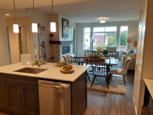 Bright common area with comfortable seating and a dining table