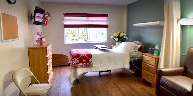 A private resident room with a bed and amenities