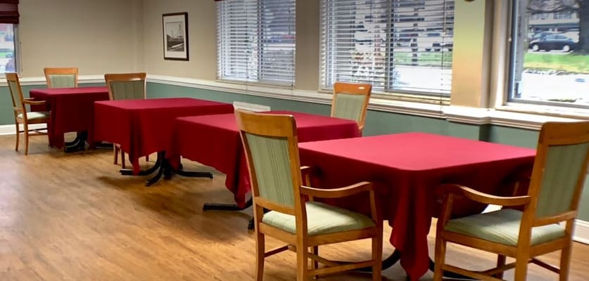 Dining area with tables covered in red tablecloths