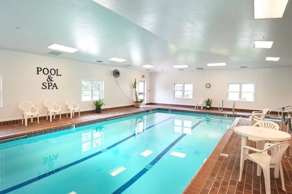 Indoor pool and spa area with seating