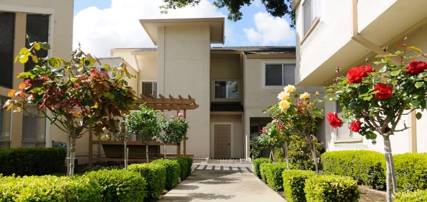 Pathway lined with flowers and greenery at Fremont Village