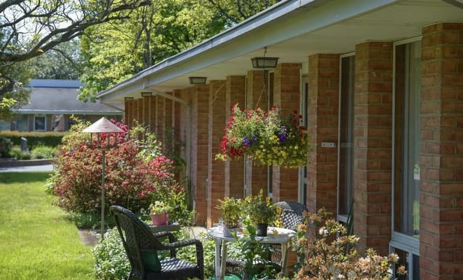 Outdoor seating area with flowers and greenery