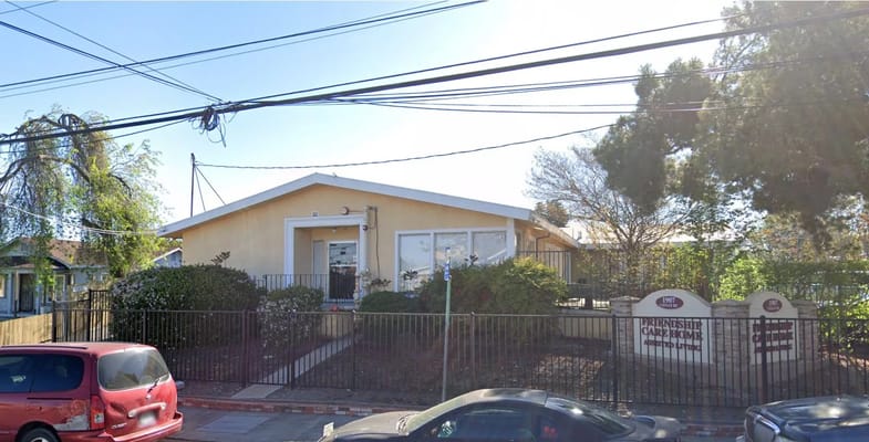 Exterior view of Friendship Care Home with garden