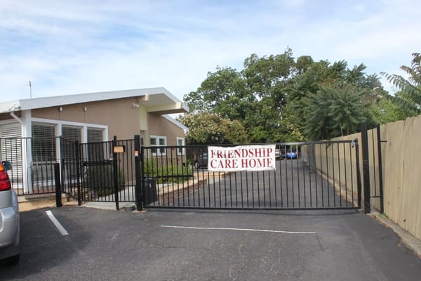Entrance gate of Friendship Care Home with signage