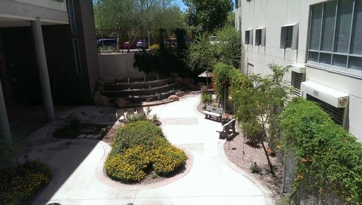Outdoor garden area with seating and water feature