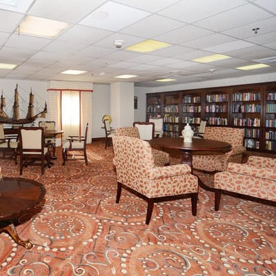 Library lounge area with comfortable seating and shelves of books