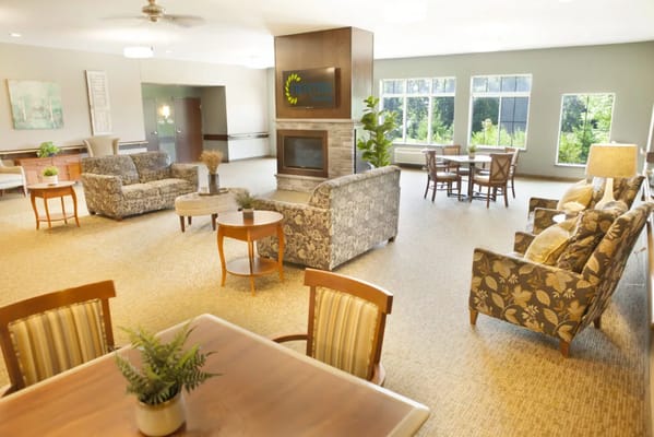 Bright common area with seating and large windows