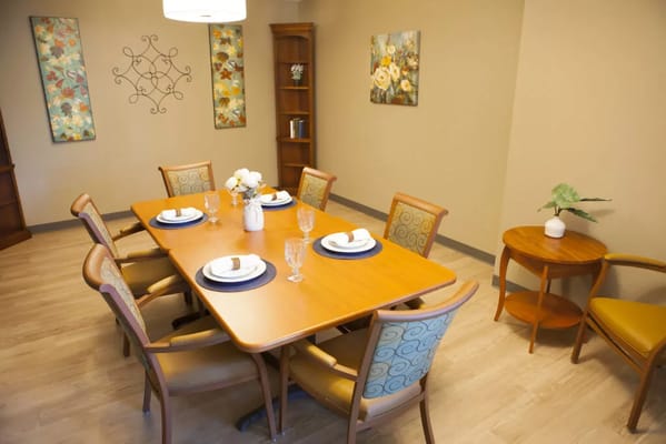 Tastefully arranged dining room with flowers and dinnerware