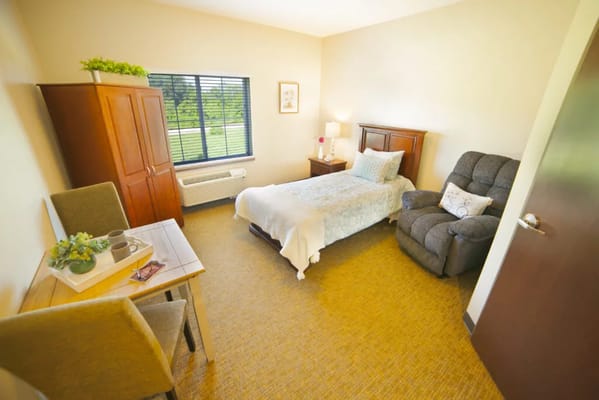 Cozy resident room with a bed and chair