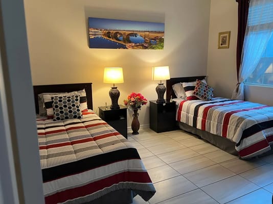 Cozy shared bedroom with twin beds and decorative artwork