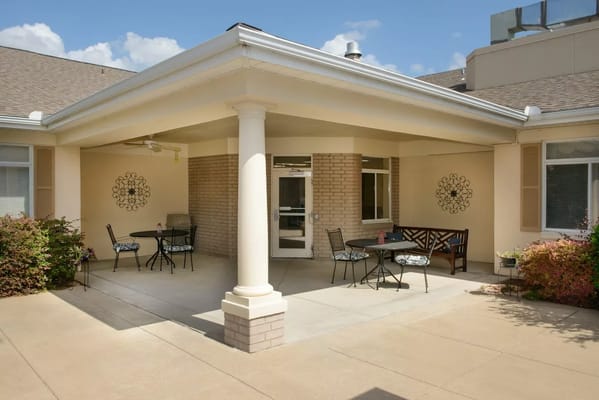 Patio seating area with tables and chairs at Garden Terrace, Fort Worth.