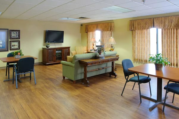Spacious common area with seating and tables at Garden Terrace.