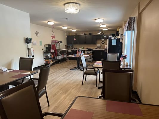 Dining area with tables and kitchen appliances
