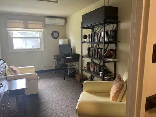 Cozy residential room with seating and a desk