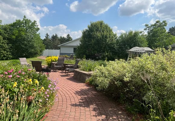A tranquil garden space with seating and blooming flowers