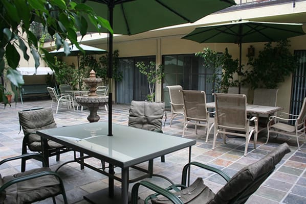 Outdoor seating area with tables and umbrellas