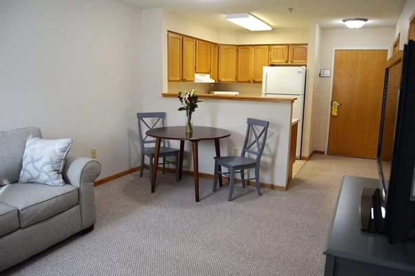 Living room with a table, two chairs, and a couch.