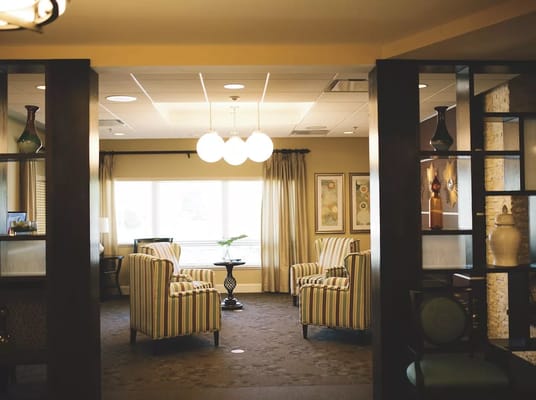 Lounge area with striped chairs and natural light