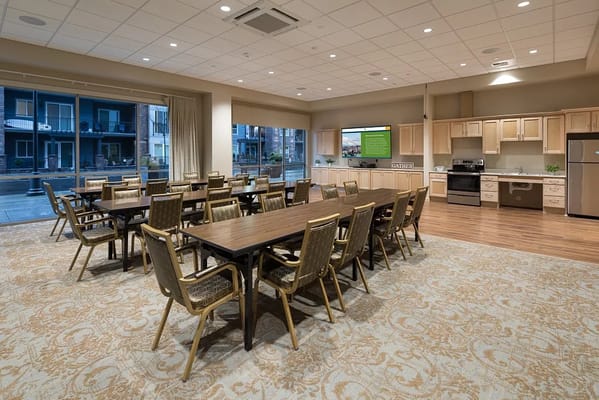 Bright dining area with tables and kitchen visible