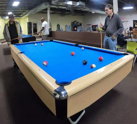 Residents playing pool in an activity room