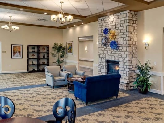 Interior common area with seating and a fireplace